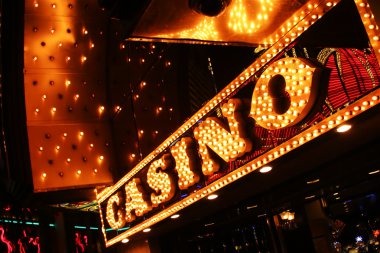Mobile interface showing Casino Hold'em betting controls and live dealer feed